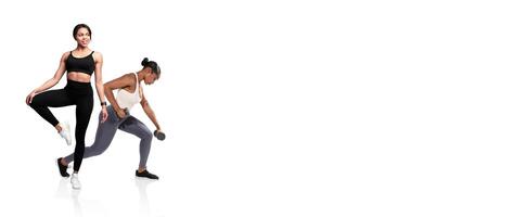 Two individuals perform fitness routines in a bright gym space. One demonstrates a leg raise while the other lifts weights, showcasing a focus on health and strength training. photo
