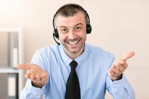 Call Center Operator In Headset Smiling To Camera Talking With Client Working Sitting In Customer Support Office photo