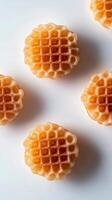 Six freshly baked waffles arranged neatly on a white surface in morning light photo