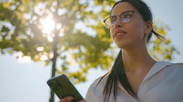 Close-up woman using mobile phone outdoors browsing social network checking email sending electronic sms message on smartphone making order in online shop booking in Internet cellphone new application photo