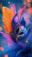 Colorful elaborately designed mask with feathers worn during a carnival celebration at dusk photo