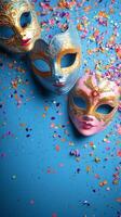 Colorful decorative masks arranged on a blue background with vibrant confetti scattered around photo