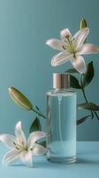 Elegant floral arrangement with a clear perfume bottle on a soft blue background photo