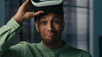 Surprised african american man take off VR glasses in 3D metaverse world play online male gamer enjoying game using virtual reality headset satisfied with modern innovative technology concept photo