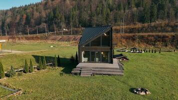 Aerial view Modern cabin with panoramic countryside views, A stylish modern cabin with large windows video