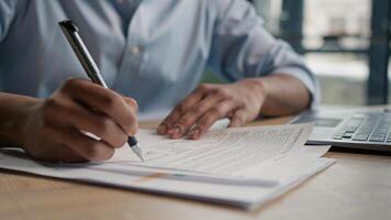 Close up unrecognizable man businessman writing paperwork report on desktop male hands signing business documents on office table student write educational test english exam studying in university photo