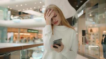 Sad Caucasian puzzled anxious female businesswoman 25s woman has problem with smartphone receive bad message on mobile phone low public internet connection upset dissatisfied girl lady express despair photo