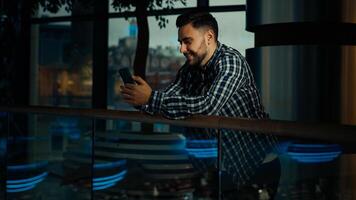 Young man businessman caucasian hispanic male client guy stand in modern business office hold smartphone chatting online use mobile phone banking app browsing website play internet games on cellphone photo