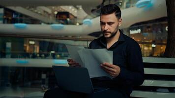 Caucasian male businessman young entrepreneur ethnic man worker lawyer work with documentation read business documents check financial contracts paying bank loan bills online use computer cyberspace photo