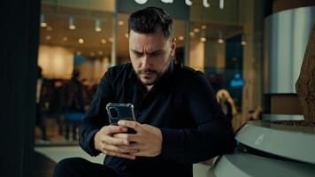 Upset anxious businessman 30s man having problem with mobile telephone read bad news unpleasant email on phone software error receive denial answer fail business deal disappointed male make mistake photo