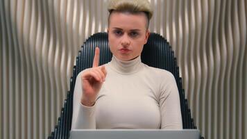 Female programmer serious business worker businesswoman hacker developer woman girl in modern futuristic space work laptop play computer game virtual tech cybersecurity shaking finger no refuse reject photo