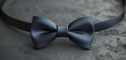 Close Up of a Dark Blue Bowtie on a Grey Surface photo