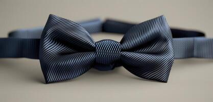 Close Up of a Dark Blue Bowtie on a Grey Surface photo