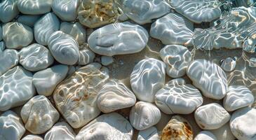 Smooth White Stones Under Clear Shallow Water on a Sunny Day photo