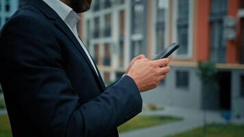 Close-up male hands touch mobile screen hold modern gadget phone device millennial adult man chatting send message in web chat online business communication check media content use virtual banking app photo