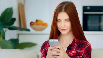 Amazed young user girl ginger student schoolgirl teenager use mobile app on phone shopping online make order win discount in internet store click on display cell option. Advertisement of modern gadget photo
