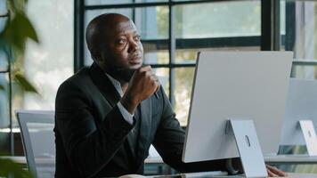 Thoughtful dreamy african man executive worker teacher male team leader has dilemma question thinking decision brainstorming create startup project business strategy turn pen in hand ponder new idea photo