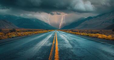 Straight Road Leading Towards Lightning Storm in Mountains photo