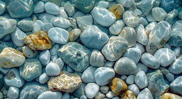Smooth White And Blue Stones Under Clear Shallow Water On A Sunny Day photo
