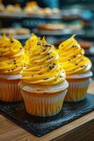 Three Yellow Cupcakes with Chocolate Sprinkles photo
