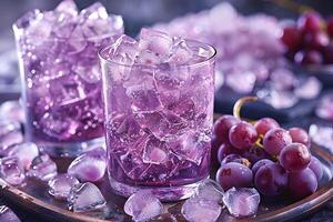 Two glasses filled with purple drinks and ice, surrounded by grapes and ice cubes, creating a refreshing beverage scene. photo