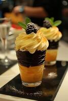 Two Desserts with Whipped Cream, Chocolate and Orange Flavors photo