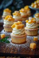 Mango Cupcakes with Creamy Topping and Powdered Sugar photo