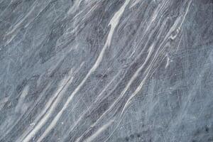 This gray marble features beautiful white veining, highlighting its natural patterns and ideal use for elegant surfaces and decor photo