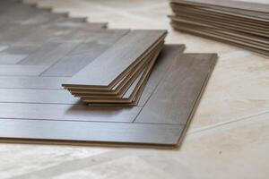Laminate floor installation in a modern apartment, showing tools, planks photo