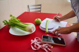Healthy lifestyle concept with fresh celery and apple on table photo