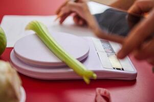 Celery on digital scale with focus on healthy eating photo