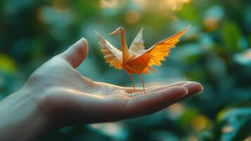 The image of a hand holding a small graceful origami crane demonstrates the beauty of a simple handmade creation and evokes a sense of peace. photo
