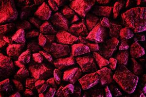 Trending space minimal neon red background with stones. Asteroid or comet stones in fluorescent creative lighting. photo