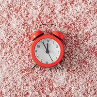 Classic retro alarm clock on a red background photo