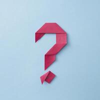 Neatly folded origami red paper question mark photo