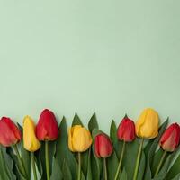 A bunch of pink and yellow tulips on a green background and copy space for your text invitation to a festive event or meeting. Valentine's or mother's day concept. photo