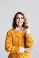 Young Woman Student Has Eureka Moment - Excited, Clever, Pointing Up with New Idea - Wow Promotion Offer Presentation - Conceptual Image of Innovation and Insight - Isolated on White Background. photo