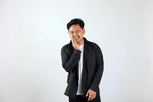 Young Asian Man Standing Over White Background Touching Mouth with His Hand photo