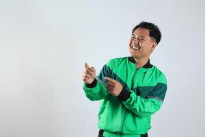Asian Gojek Grab Online Driver with Unifrom Jacket Pointing at Copy Space photo