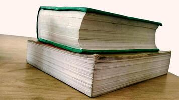 closeup of two old rustic books lying on wooden table. Education concept photo
