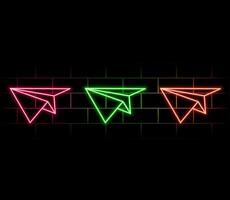 Glowing neon Paper airplane icon isolated on brick wall background. vector