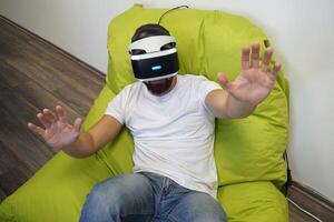 Man Interacting with Virtual Reality Environment in Relaxed Setting photo