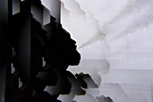 Silhouette of bearded vaper man with cloud of vapor, black and white with kaleidoscope effect photo