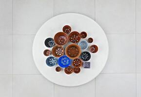 Assorted Flower Pots Arranged in Circular White Table photo