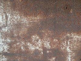 a rusty metal surface with some paint on it photo