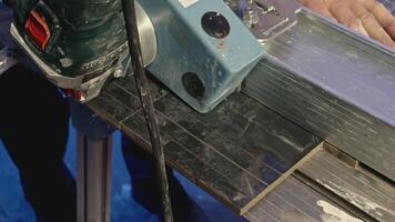 Close up of cutting narrow tiles of ceramic panel with circular saw and water. Creative. Industrial background with using of professional equipment. video