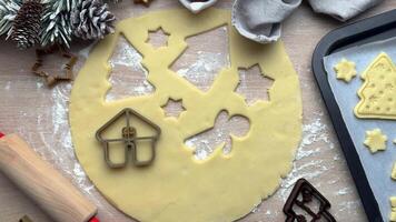 Baker adding christmas cookie cutters to dough video
