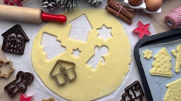 Baker adding christmas cookie cutters to dough video
