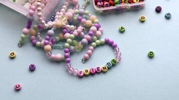 Crafting colorful bracelets with beads and tools on a table video