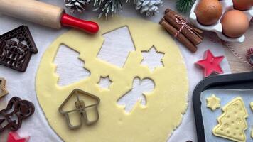 Baker adding christmas cookie cutters to dough video